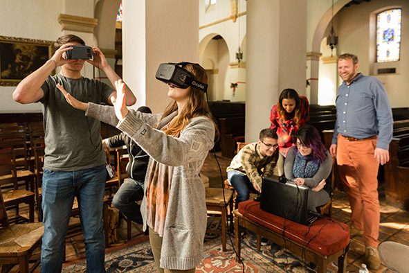 Religion students in Todd French’s God, Robots, Technologies of the Self course consider the juxtaposition of Knowles Memorial Chapel with sacred virtual spaces using virtual reality headsets.
