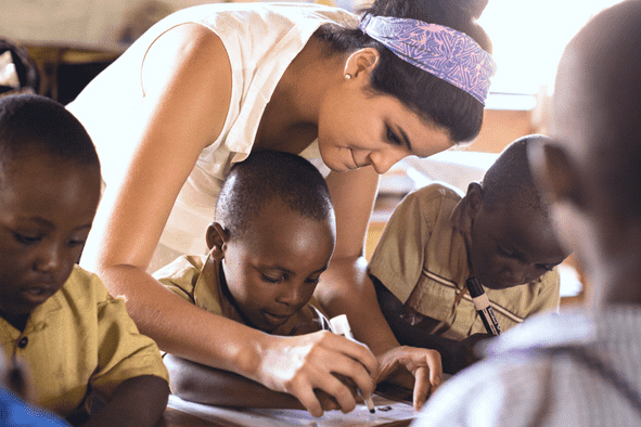 Engage meaningfully with locals like this Rollins student in a classroom in Rwanda.