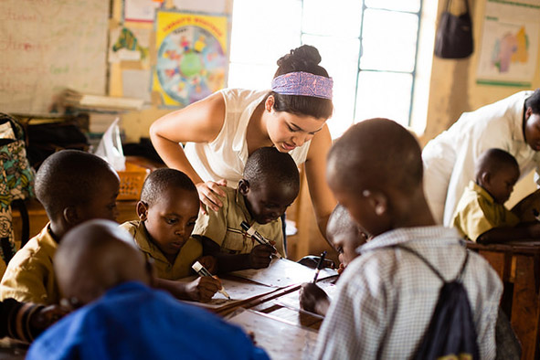 Engage meaningfully with locals like this Rollins student in a classroom in Rwanda