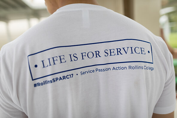 Student shirt reads "Life is for Service"